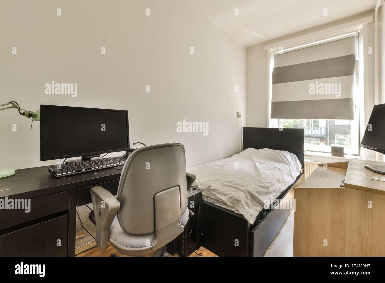 Computer Screen Bed a bedroom with a bed, desk and computer monitor on the wall in front of ...