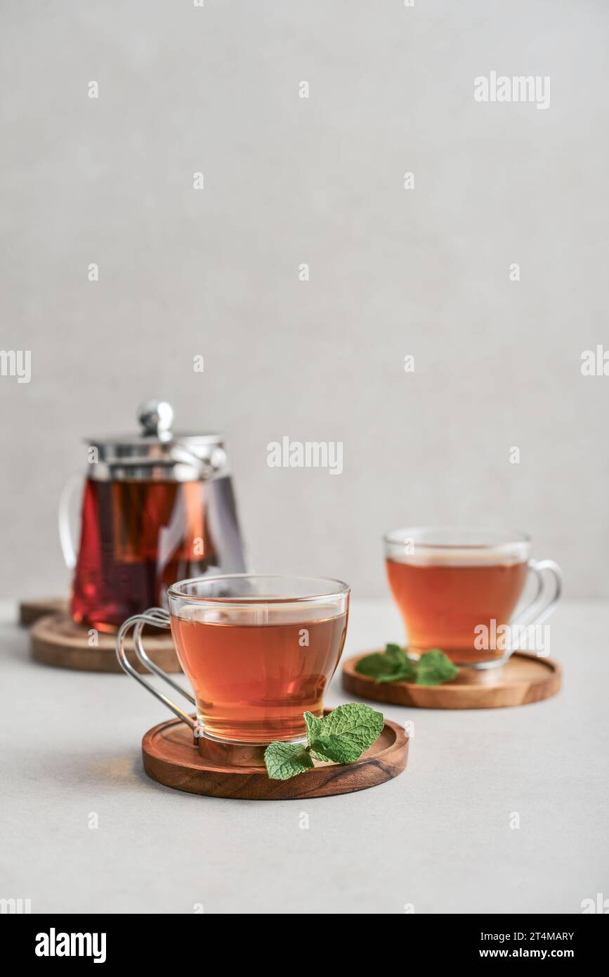 Tea  in a glass cups with  glass teapot on a light  background  closeup Stock Photo