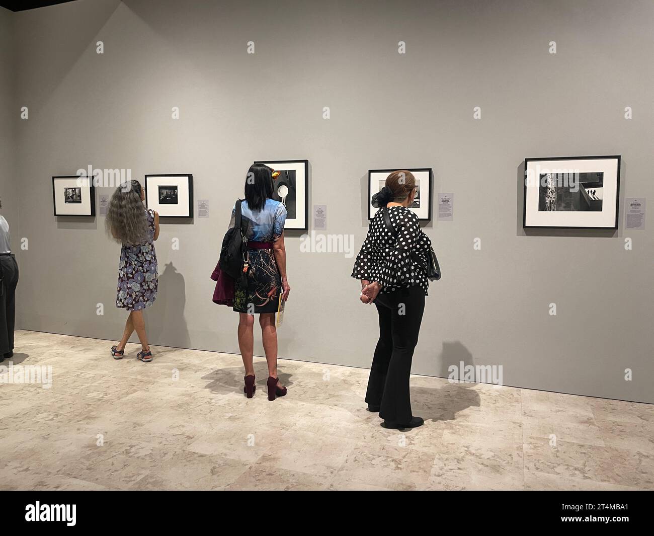 People looking at photographs in the exhibit The Power of Photography at the Bowers Museum in Santa Ana, CA, USA Stock Photo