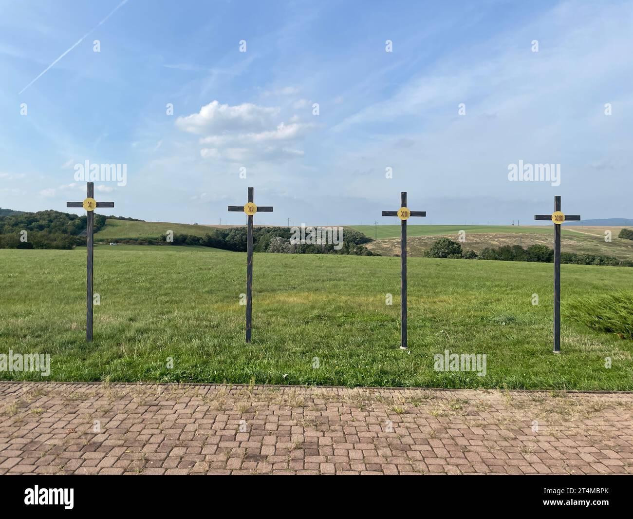 A scenic view of a green field with numbered crosses in Myjava, Slovakia Stock Photo