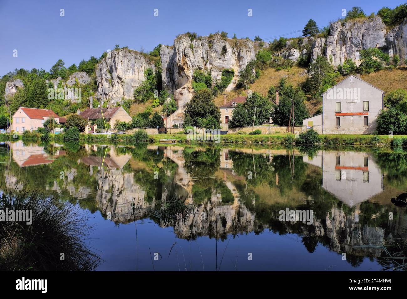 Les Rochers du Saussois (rock cliffs) and River Yonne with mirror reflections at commune of Merry sur Yonne, Burgundy, France Stock Photo