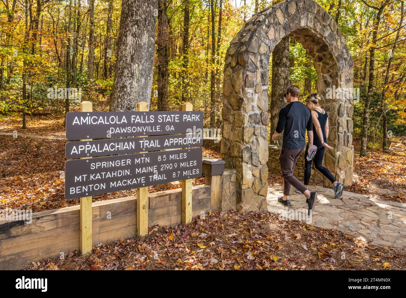 Couple passing through the stone arch at the entrance to the approach trail to the Appalachian Trail's southern terminus at Springer Mountain. (USA) Stock Photo