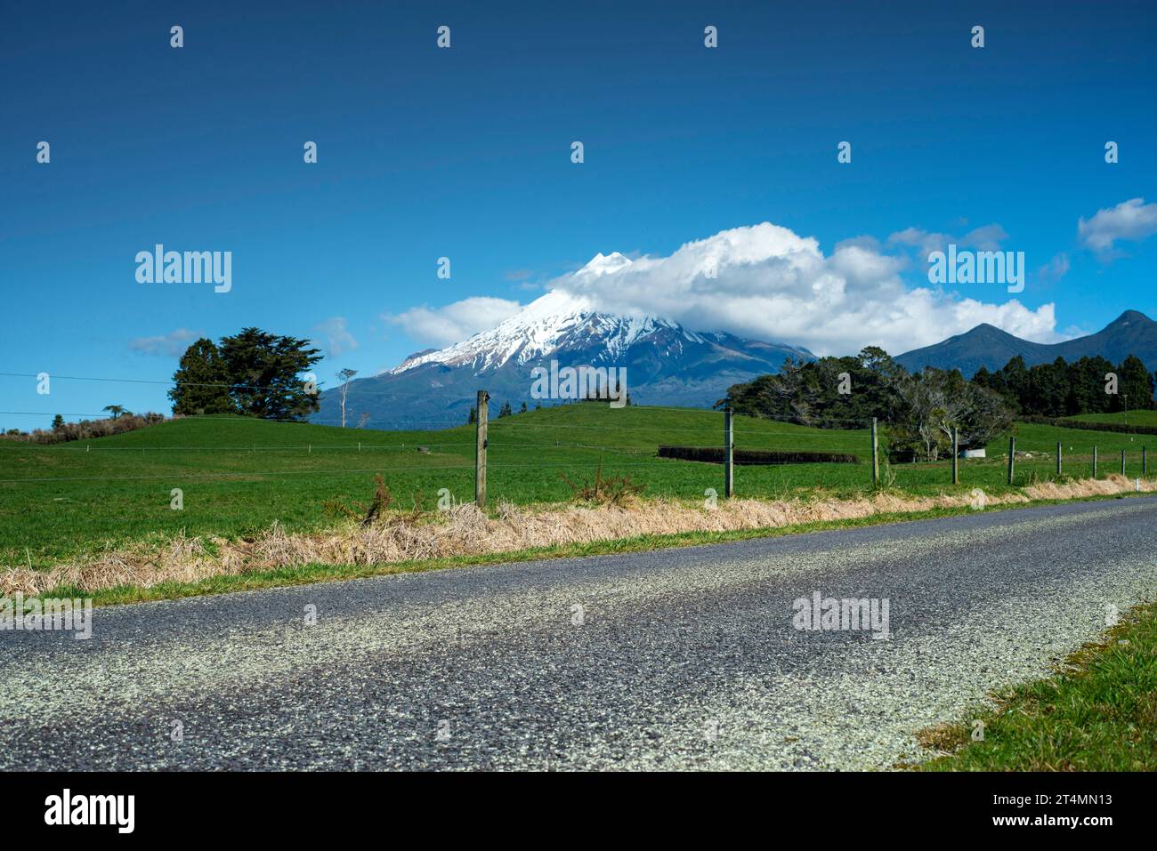 Rural backroad running through farm pasture land, Taranaki, New Zealand Stock Photo