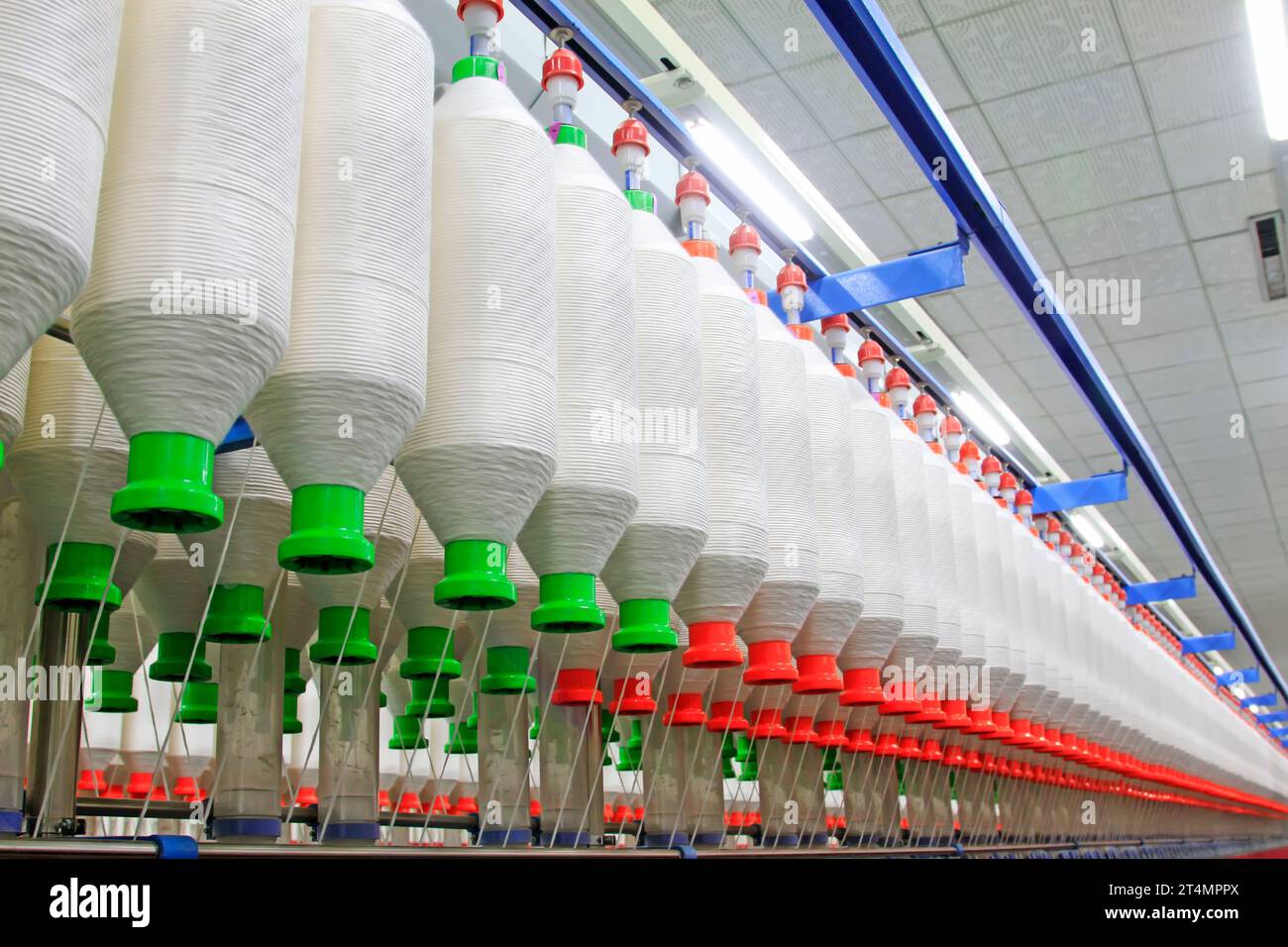 Spinning machinery parts and cotton yarn in the factory, closeup of ...