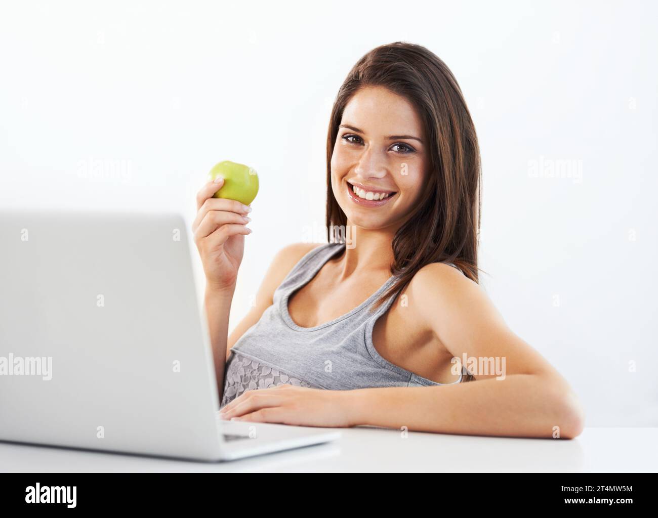 Laptop, portrait and woman nutritionist with apple in studio for ... - How To Lose Weight With A Laptop Diet
