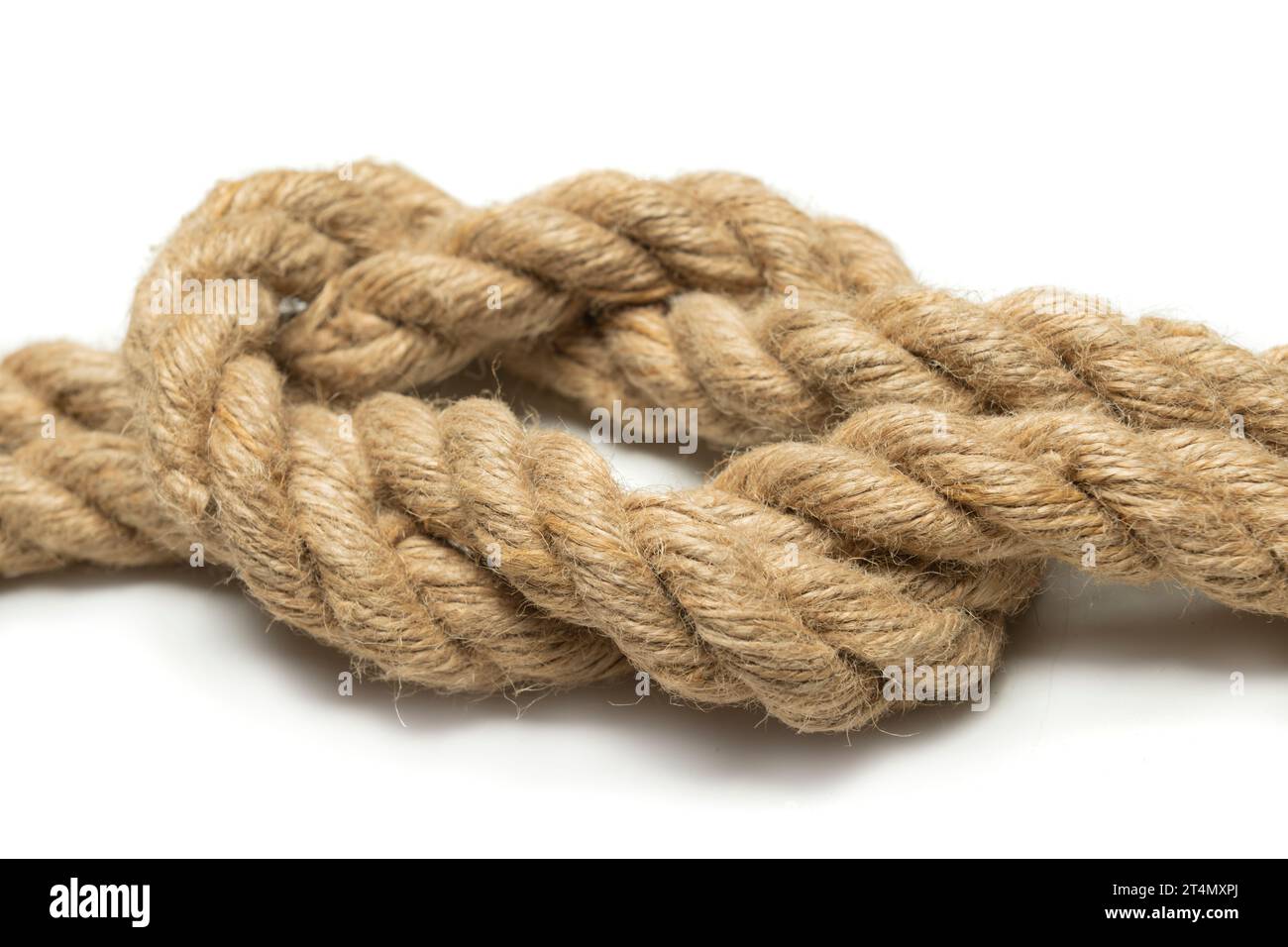 Coiled rope knot isolated over a white background Stock Photo - Alamy