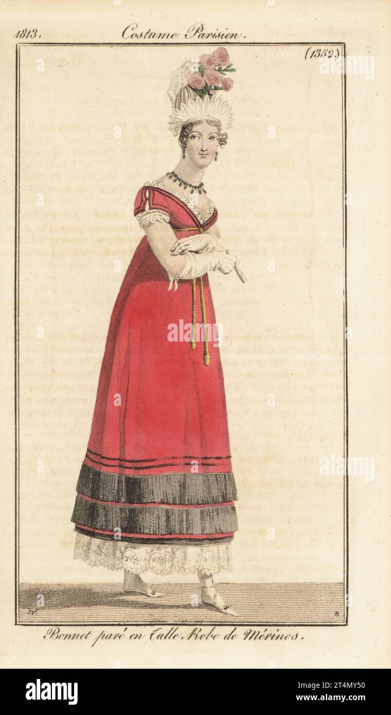 French fashionable woman in bonnet trimmed with tulle, red wool dress with lace trim. Bonnet pare en tulle, robe de Merinos. Handcoloured copperplate engraving by Jean Charles Baquoy after a fashion plate by Horace Vernet from Pierre de la Mesangere’s Journal des Dames et des Modes, Magazine of Women and Fashion, Paris, 1813. Stock Photo