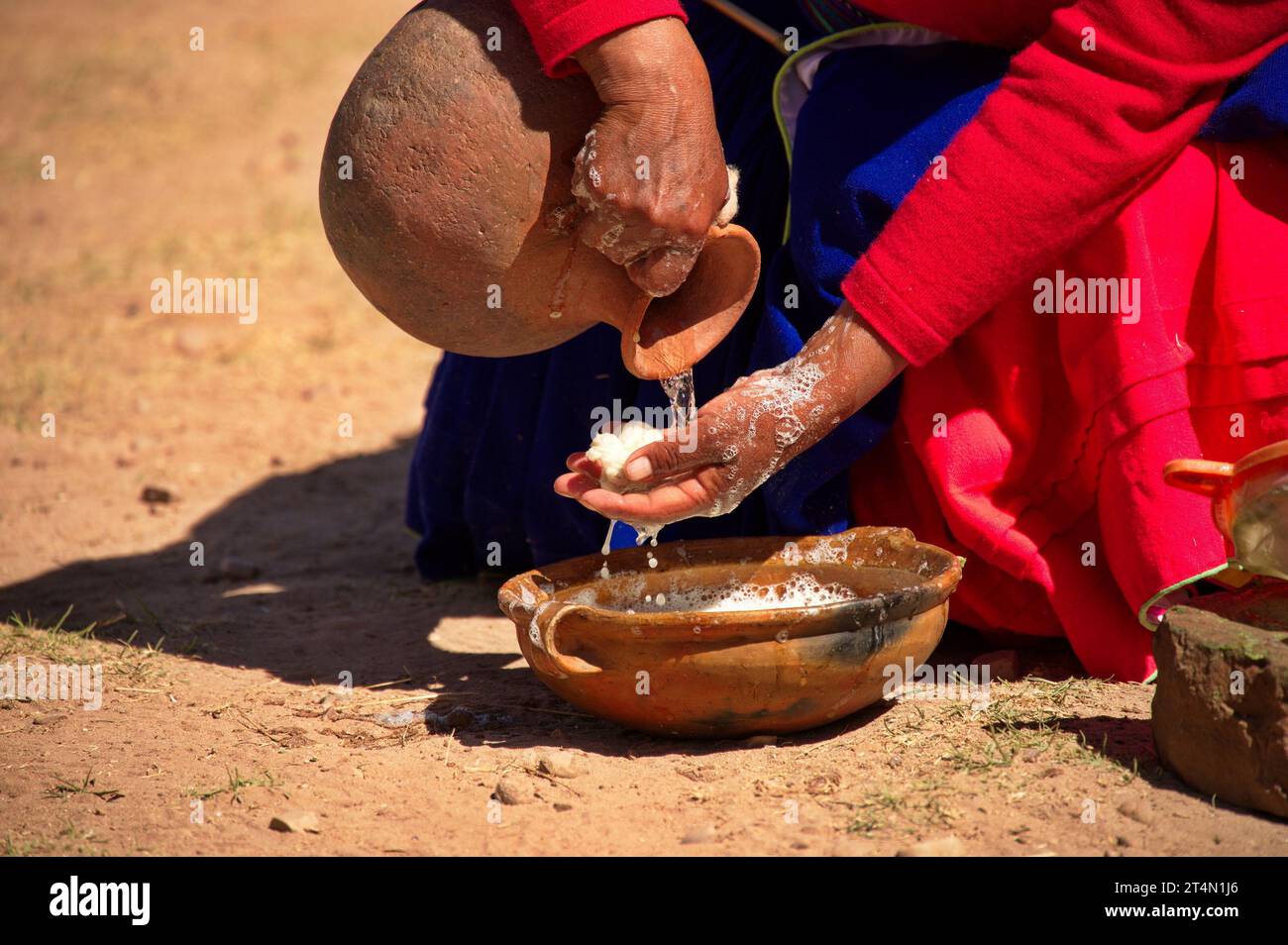 Traditional customs on the island of Taquile. A woman makes soap from natural materials Stock Photo