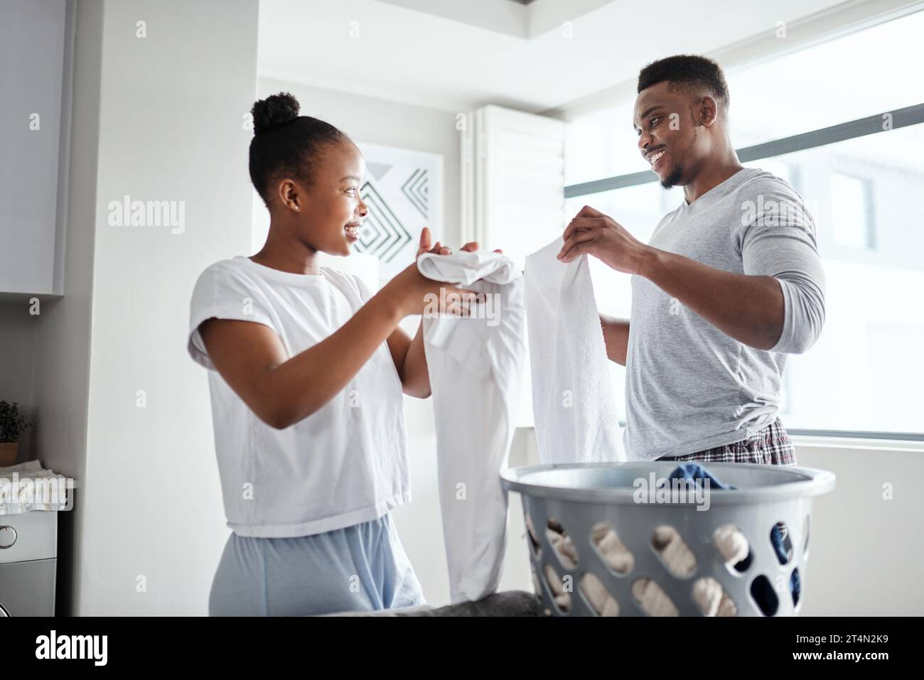 The load is smaller when we do it together. a happy young couple doing