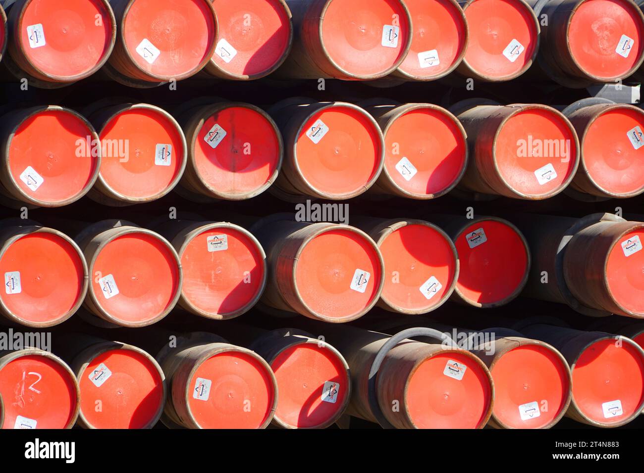 a stack of red barrels in an industrial setting Stock Photo