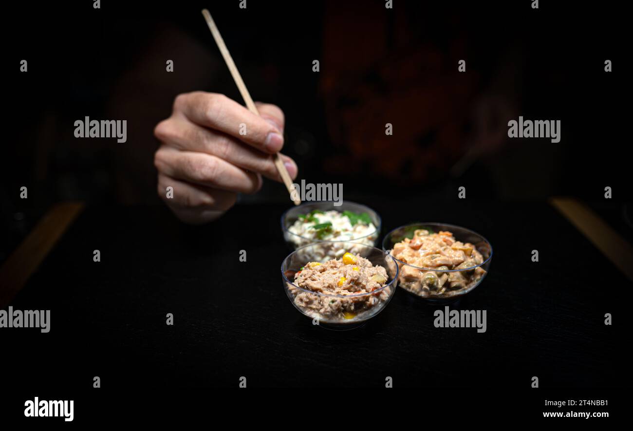 Different types of salads in a glass bowl on a black background Stock