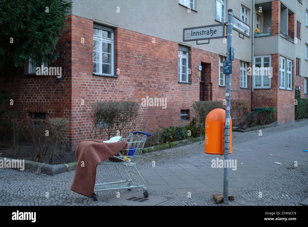 Discarded shopping cart and other detritus on the streets of Berlin-Neukölln, Germany. Stock Photo