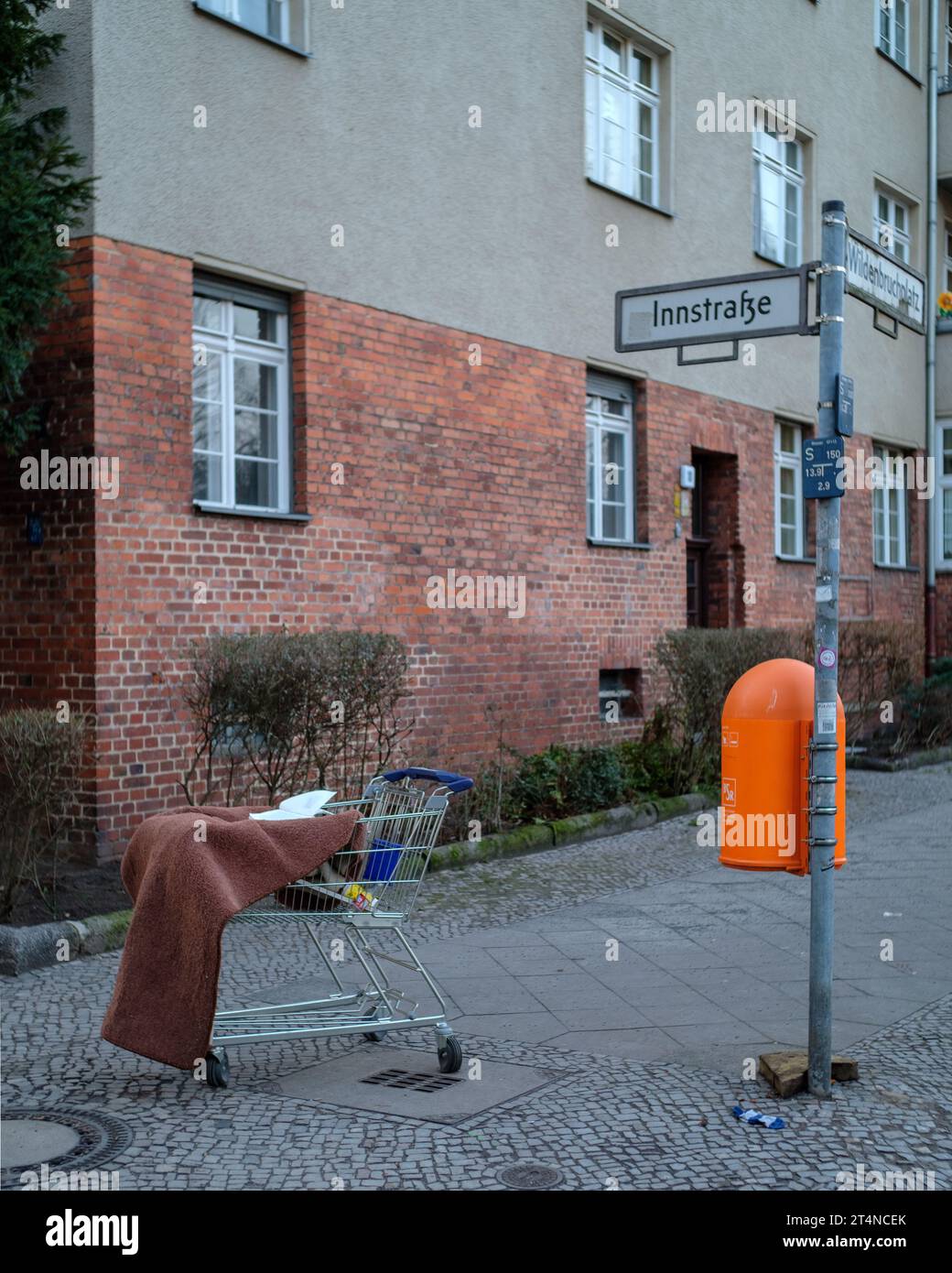 Discarded shopping cart and other detritus on the streets of Berlin-Neukölln, Germany. Stock Photo