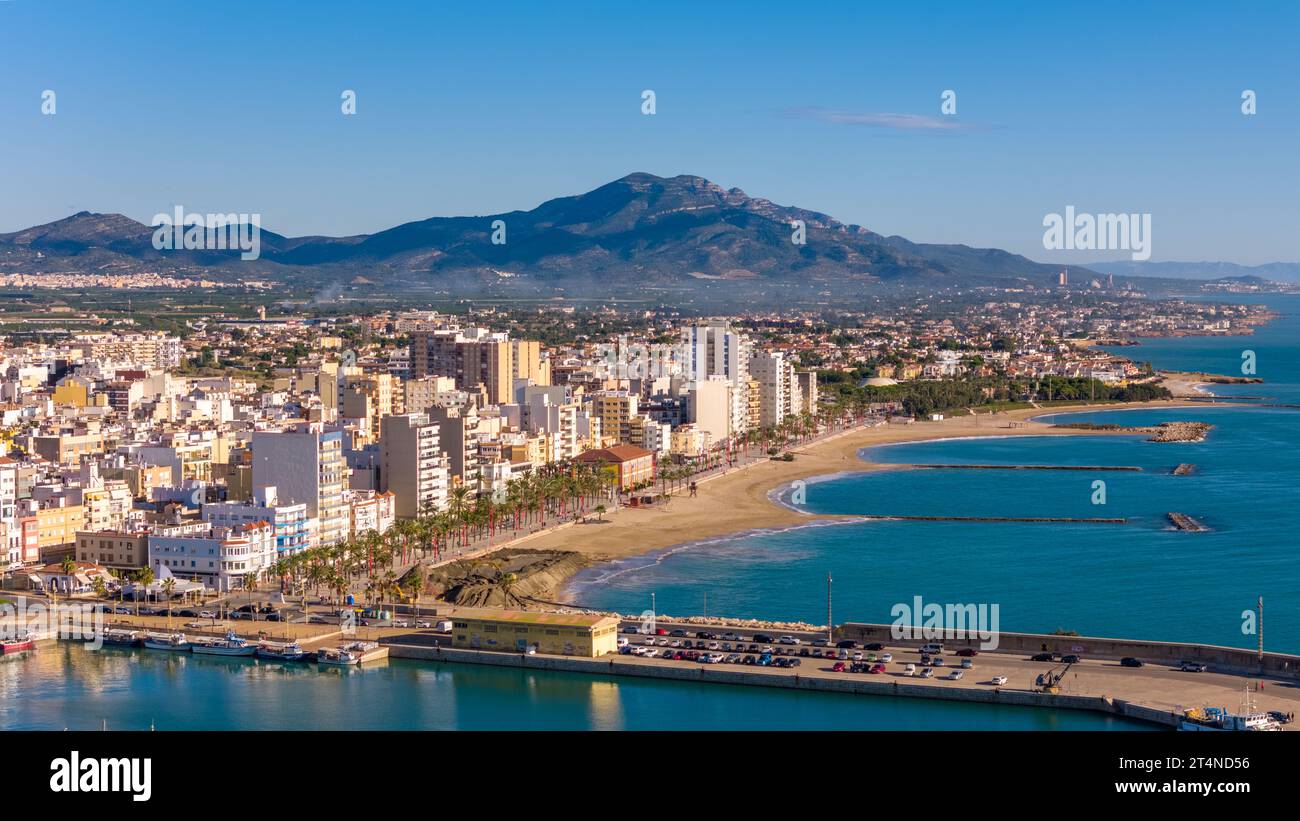 Aerial drone view on the coastal town of Vinaros in the province of Castellon, Spain. There is a boulevard and a beach next to the mediteranean sea. Stock Photo