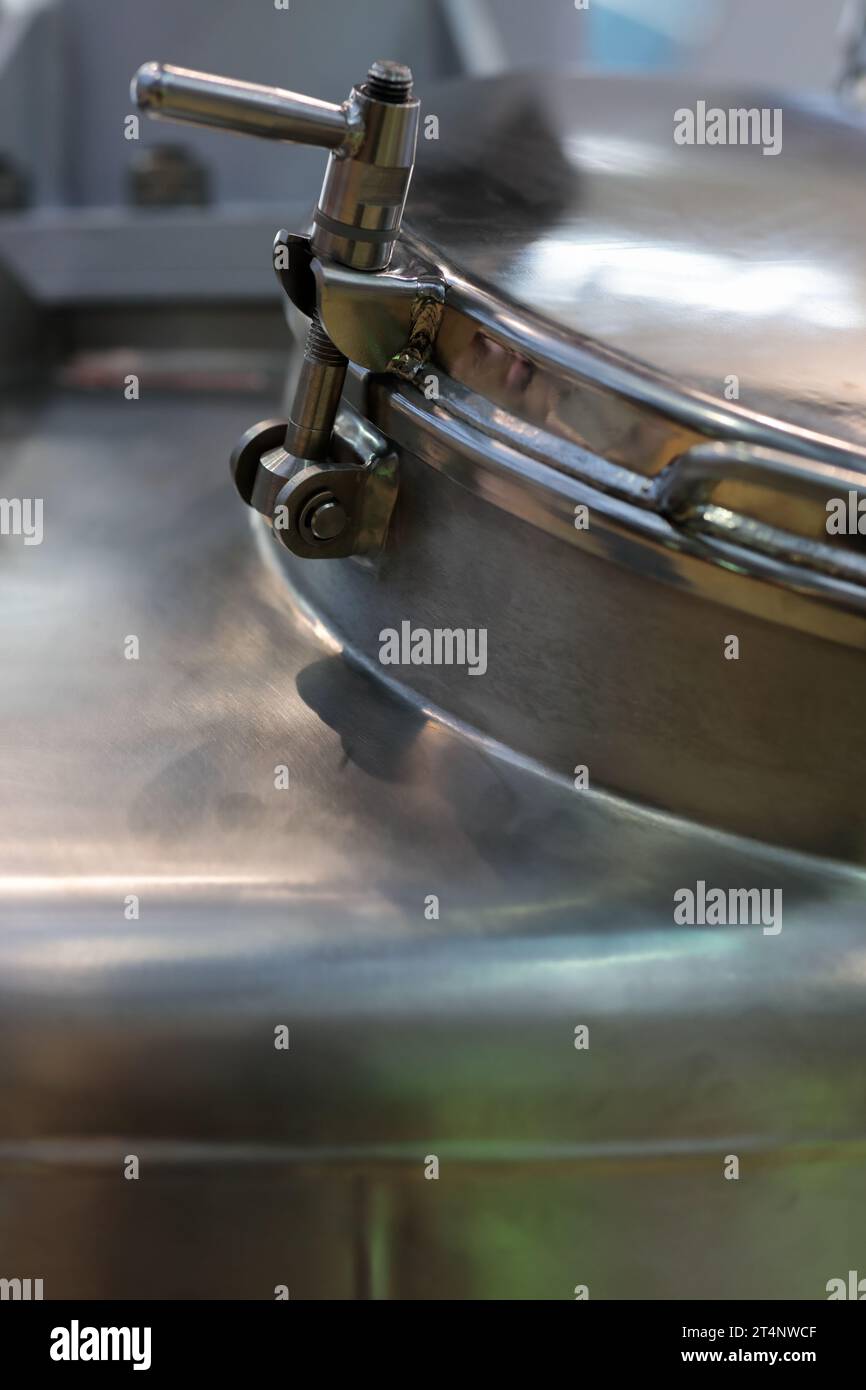 Close up of industrial stainless steel vessel. Selective focus. Stock Photo