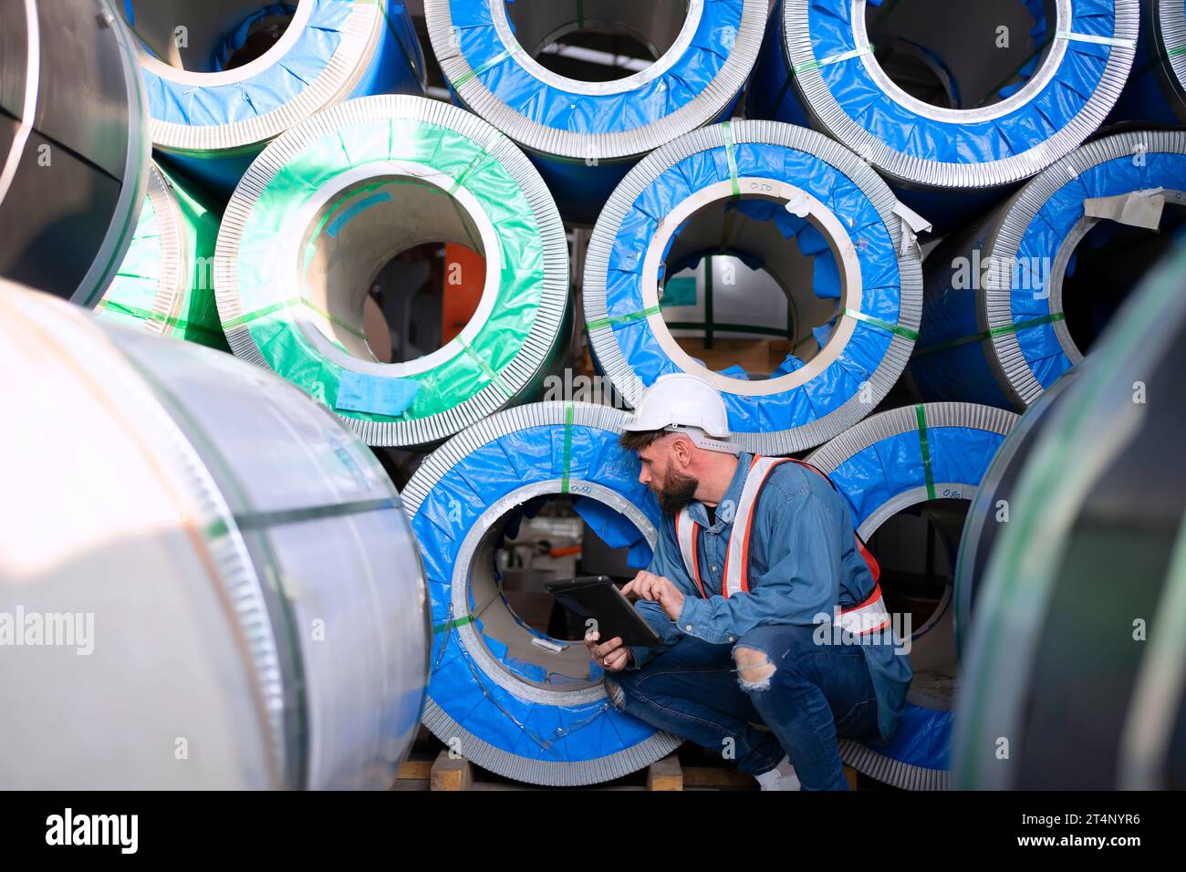 Blue collar worker work at metal sheet factory. Blue collar worker and
