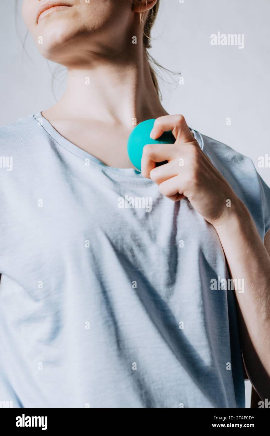 Woman using therapy ball on front chest muscles Stock Photo Alamy