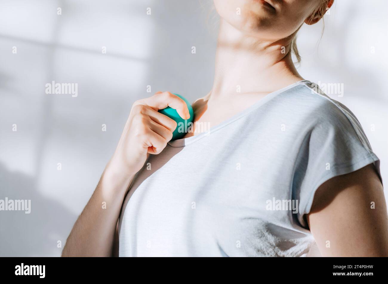 Woman using therapy ball on front chest muscles Stock Photo Alamy