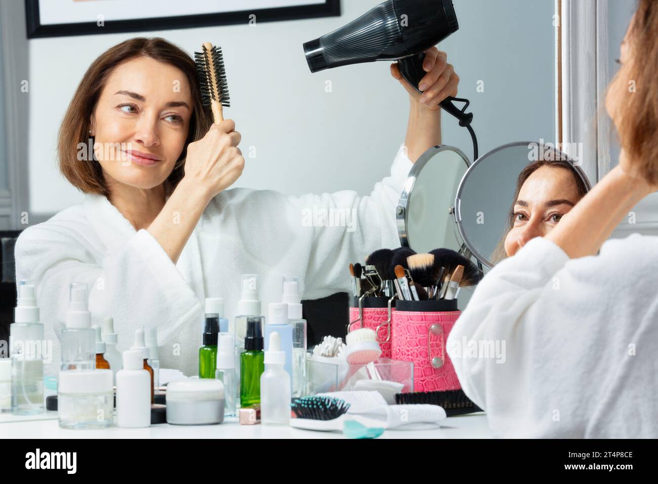 Mature woman blow dry hair hi-res stock photography and images - Alamy