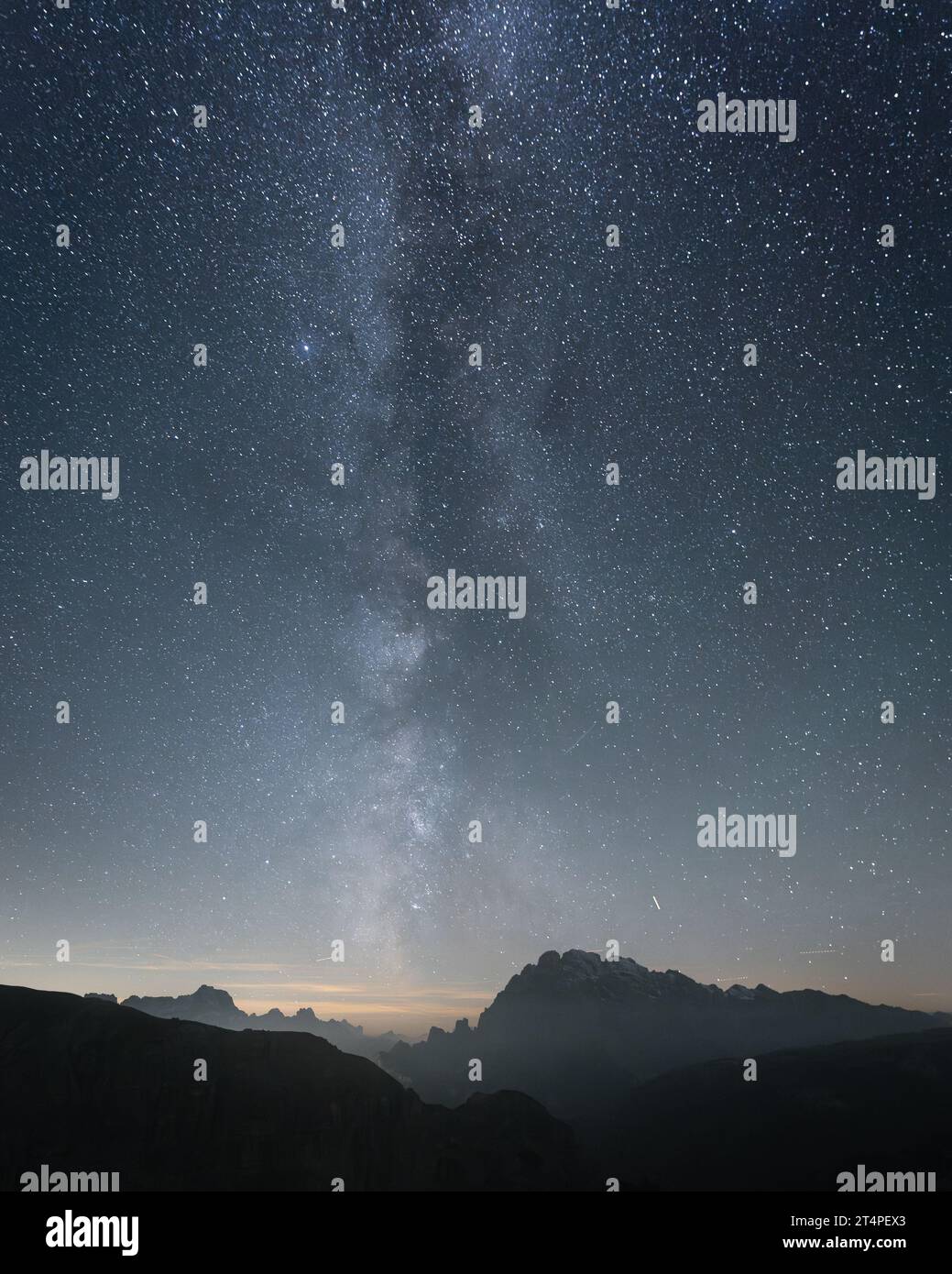 Vertical shot of starry sky and milky way above sharp mountains, Dolomites, Italy Stock Photo