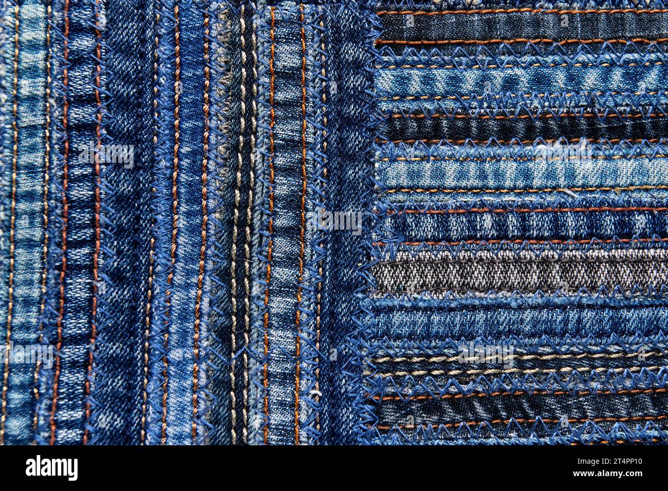 Close up view of denim fabric pattern in patchwork style, made of seams ...