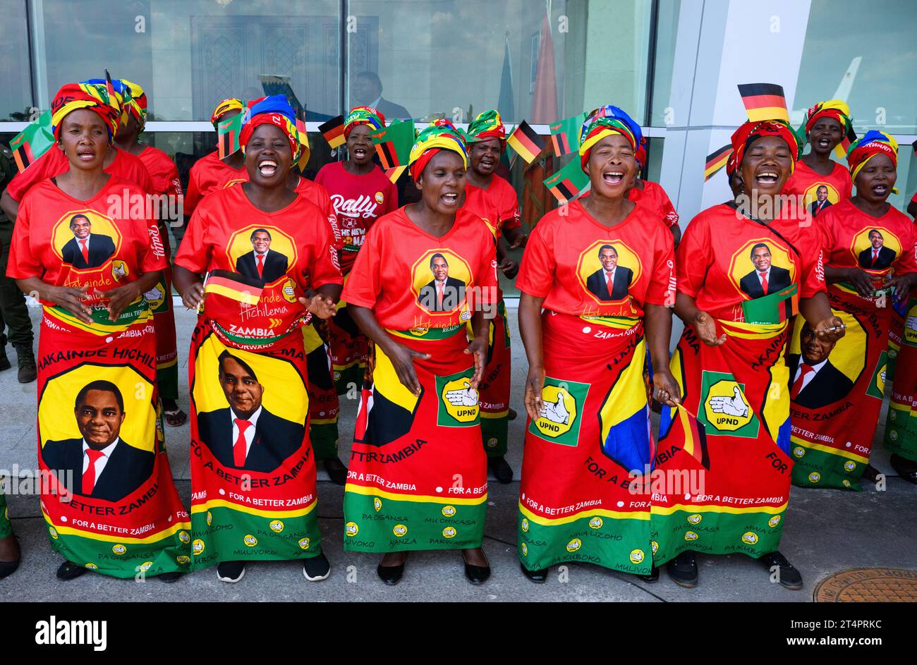 Lusaka, Zambia. 01st Nov, 2023. Women in colorful clothes with the likeness of President Hichilema sing and dance with military honors at Kenneth Kaunda International Airport in Lusaka as they welcome German President Steinmeier. President Steinmeier is visiting the East African countries of Tanzania and Zambia this week. Credit: Bernd von Jutrczenka/dpa/Alamy Live News Stock Photo