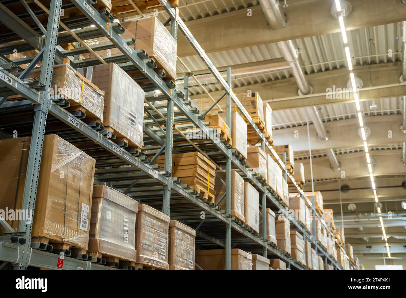 Long shelves with many cardboard boxes with product in warehouse Stock ...
