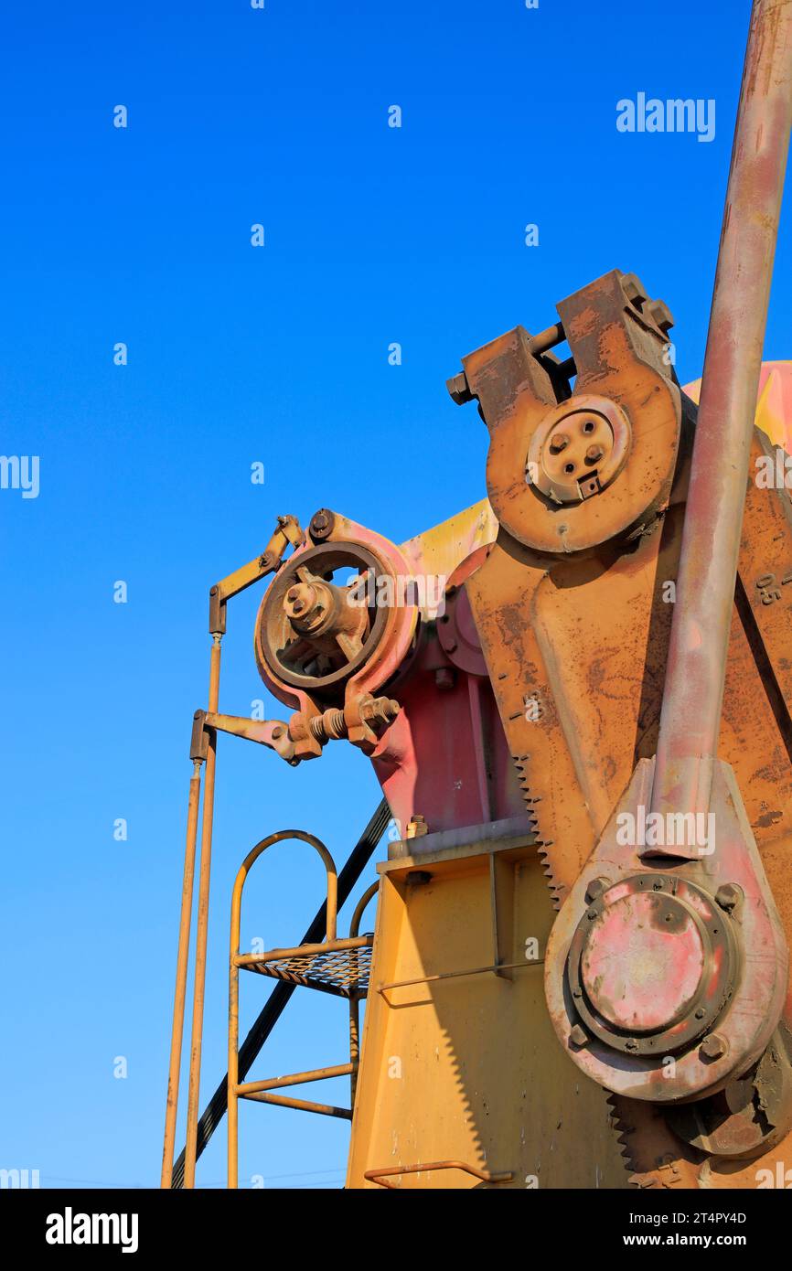 oxidation rust pumping unit parts under blue sky in oilfield Stock