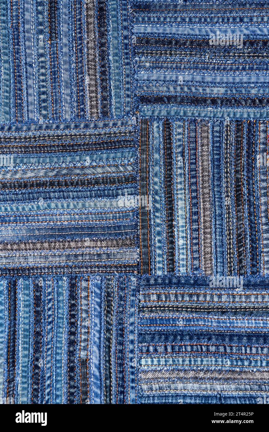 Close up view of denim fabric pattern in patchwork style, made of seams ...
