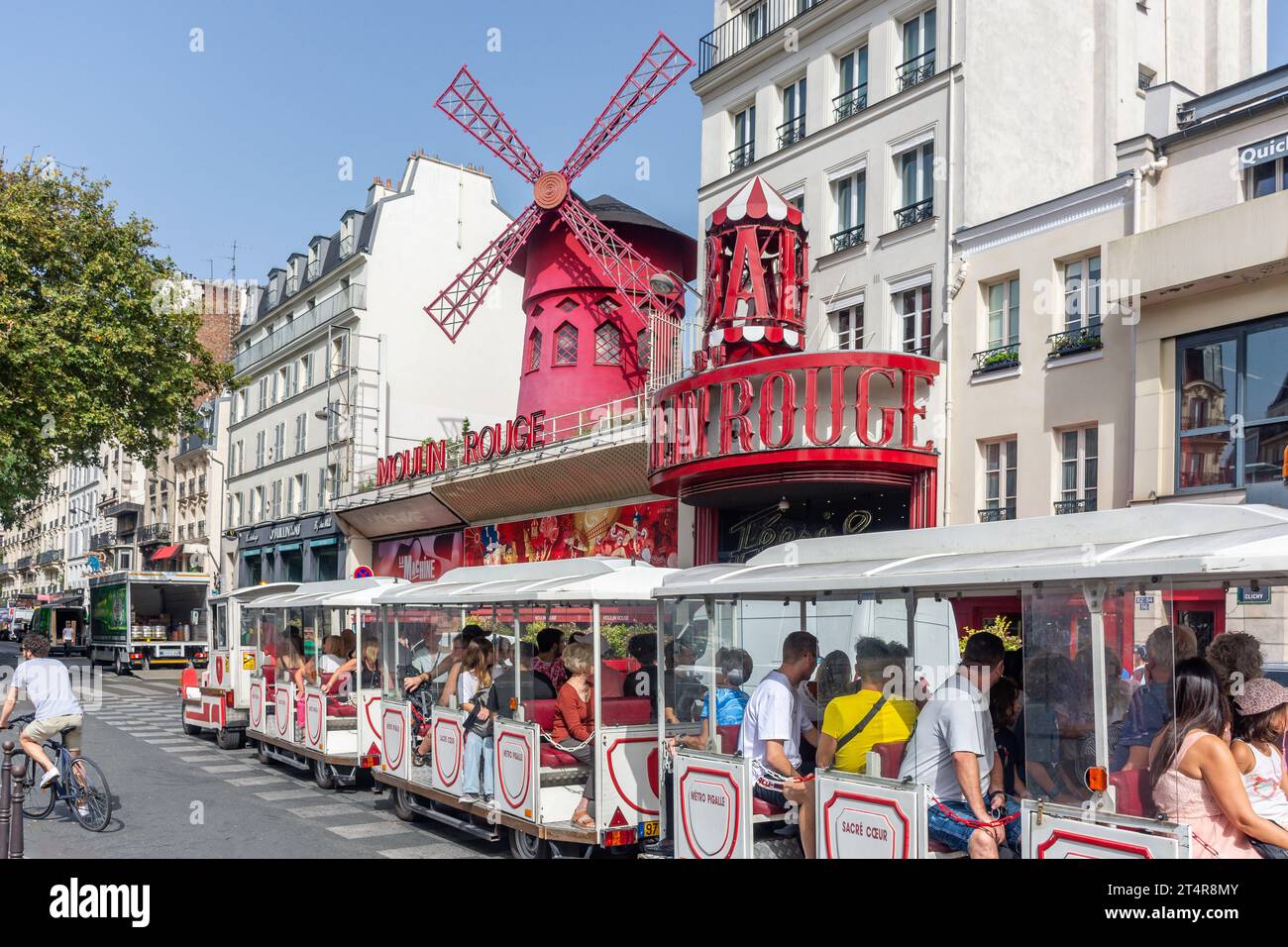 Petit Train de Montmartre passing Moulin Rouge cabaret theatre, Boulevard de Clichy, Pigalle District, Paris, Île-de-France, France Stock Photo