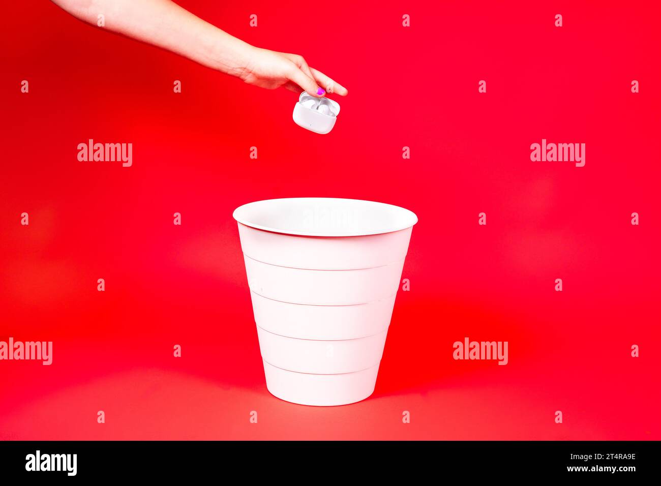 Wireless headphones is thrown into the trash for disposal and recycling