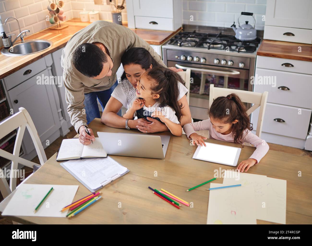 Stepping in and doing his part. two parents helping their children with ...