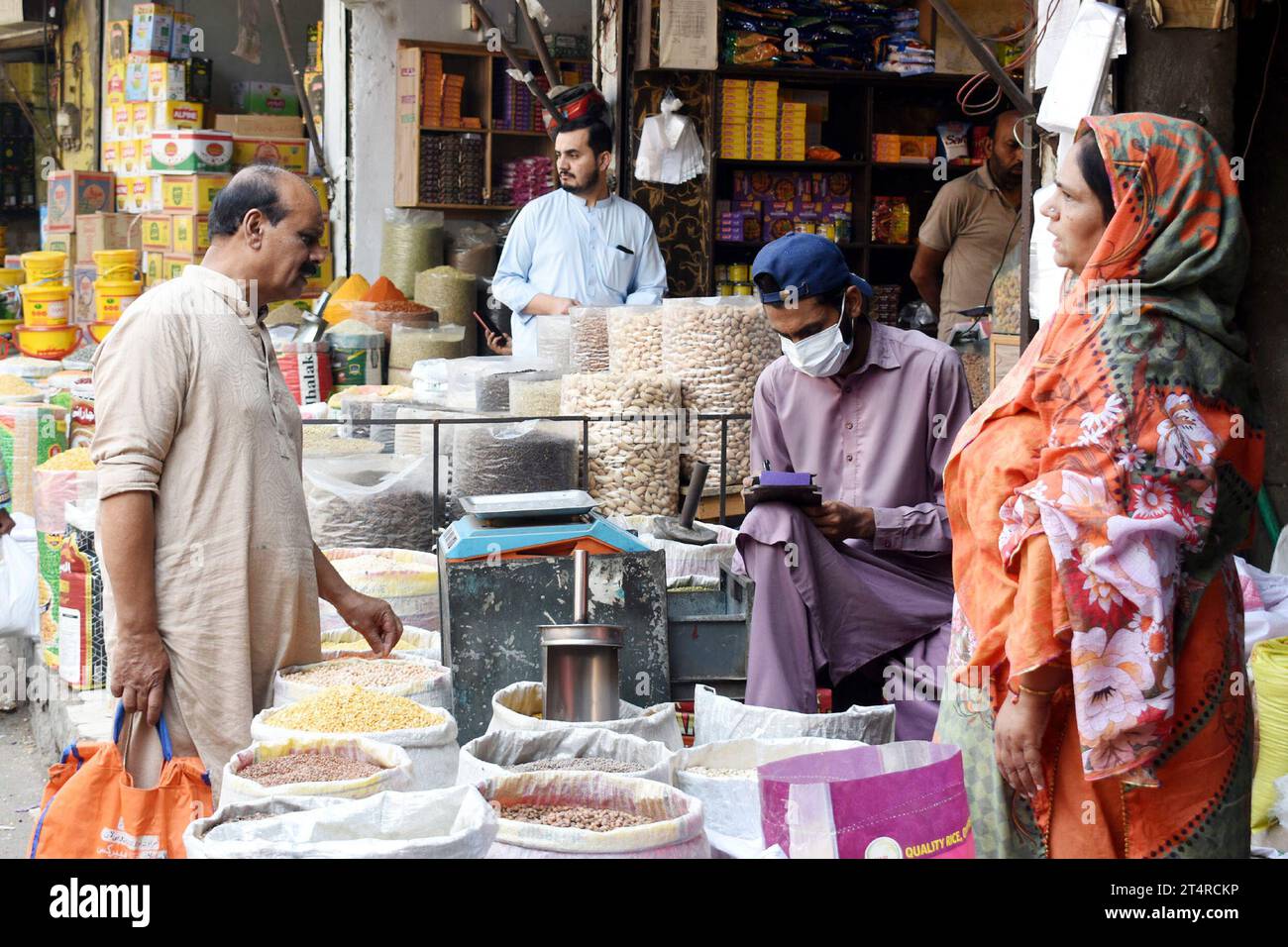 Lahore. 1st Nov, 2023. People buy daily use items from a grocery store at a market in Lahore, Pakistan on Nov. 1, 2023. Pakistan's inflation measured by the Consumer Price Index (CPI) increased by 26.89 percent year-on-year in October 2023, the Pakistan Bureau of Statistics (PBS) said on Wednesday. Credit: Sajjad/Xinhua/Alamy Live News Stock Photo