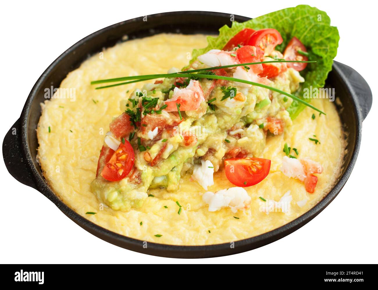 Delicious crabmeat omelette served in iron skillet with mashed avocado