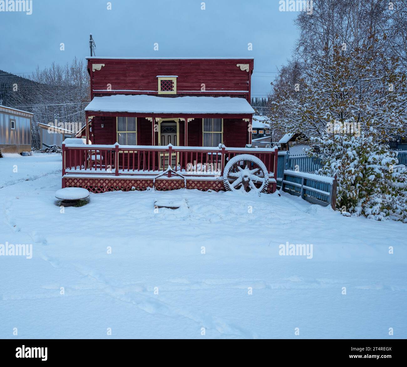 Dawson City, Yukon, Canada – October 06, 2023:  Historic red cabin with snow Stock Photo