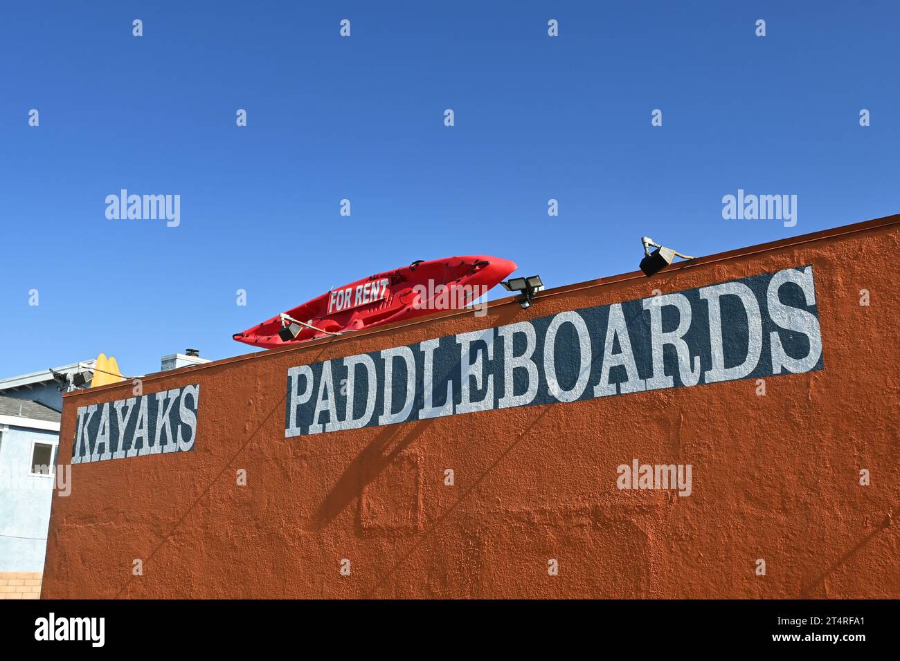 NEWPORT BEACH, CALIFORNIA - 26 OCT 2023: Kayak on top of a shop with the For Rent sign and the words Kayaks and Paddleboards. Stock Photo