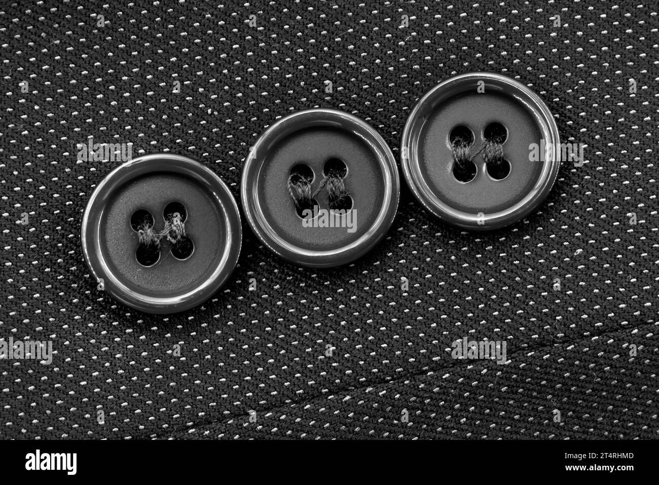 Close-up of black buttons on the sleeve of a man's jacket. Man's jacket. Button Stock Photo