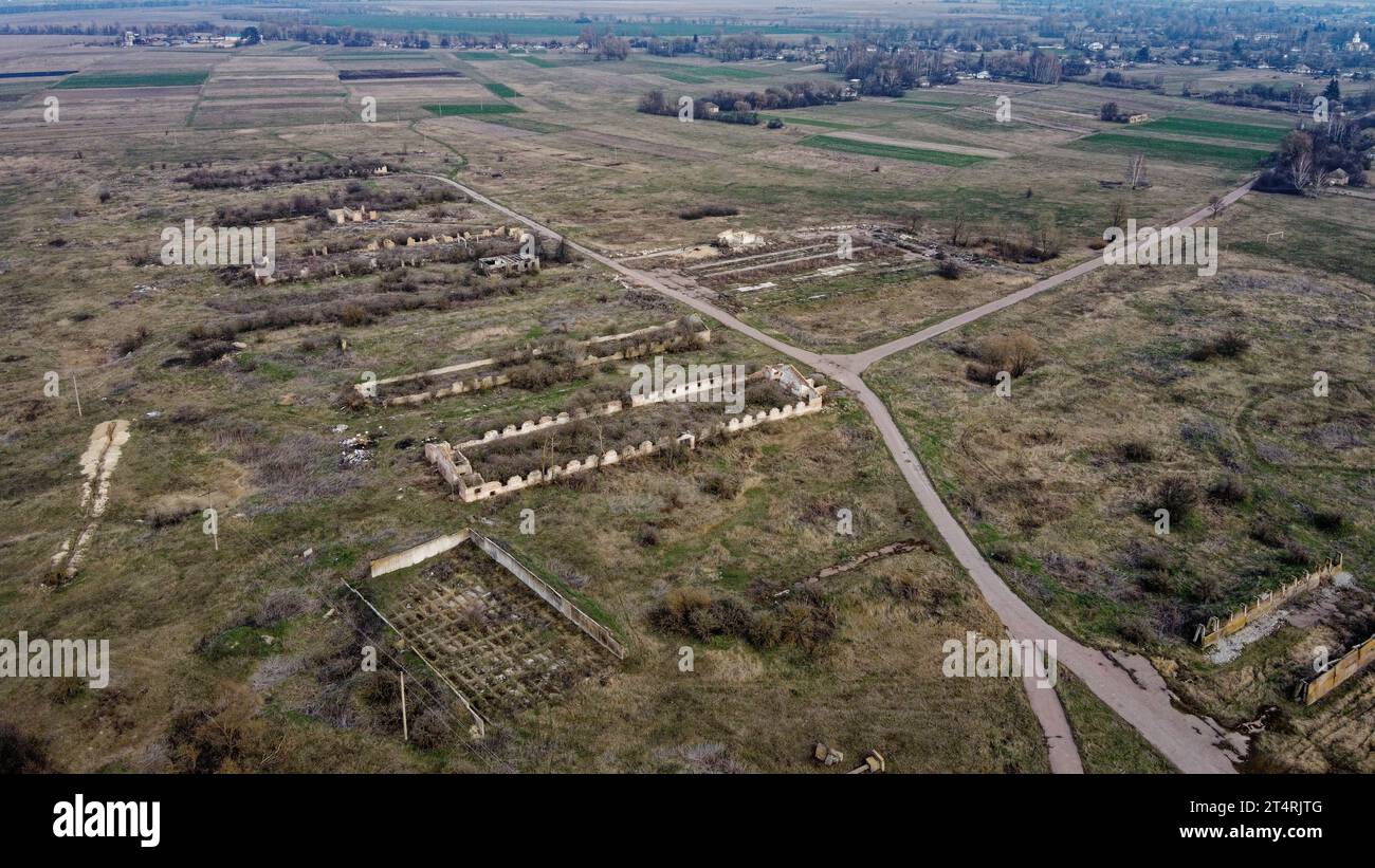 Destroyed agricultural buildings, aerial view. Abandoned livestock farm. Stock Photo