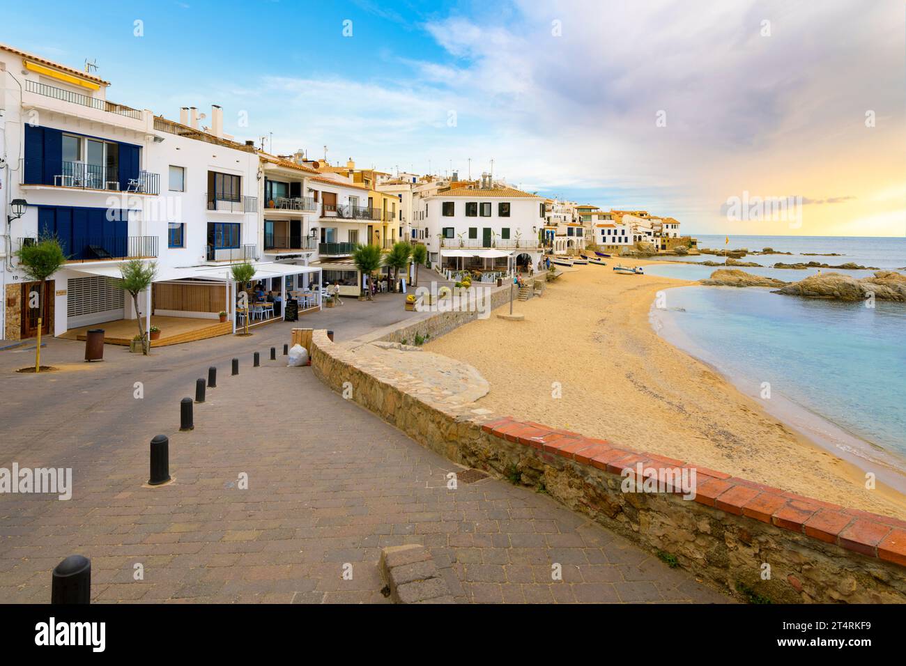 Sandy beach in front of the whitewashed fishing village of Calella de Palafrugell, on the Costa Brava coastline of the Girona Province Southern Spain. Stock Photo