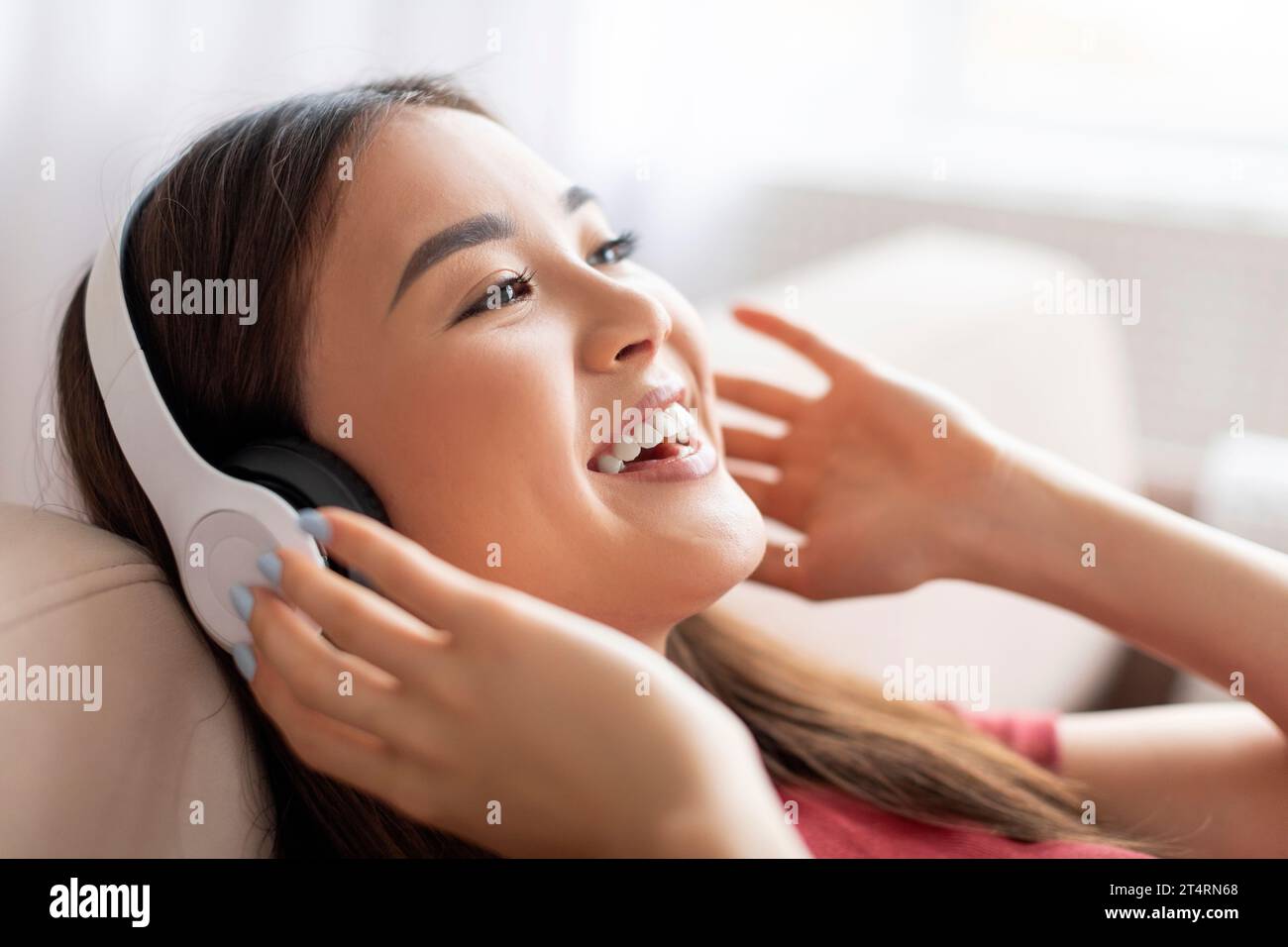 Smiling Young Asian Woman Wearing Wireless Headphones Listening Music ...