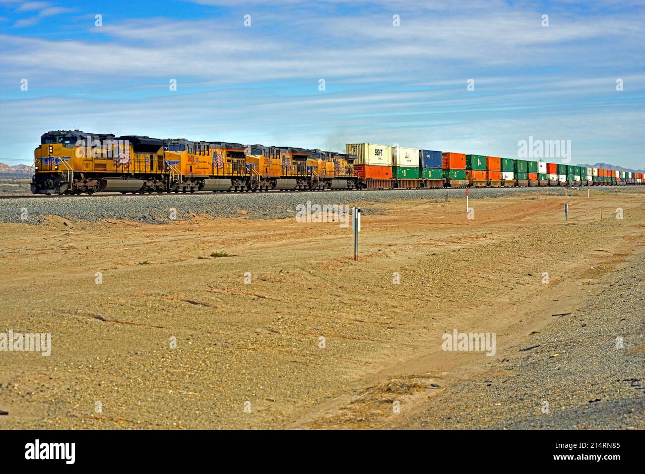 Union Pacific double stack Intermodal Freight train is seen heading west toward Long Beach near Niland on the Sunset Route in Southern California. Stock Photo