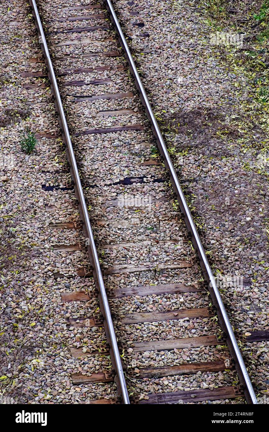 Railway bed. Fragment of railway tracks, top view, rails and sleepers. Stock Photo
