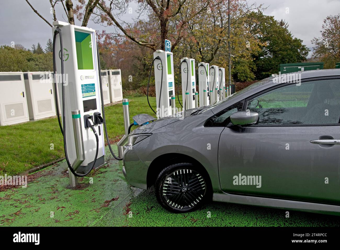 Nissan Lead electric car charging at banbk of chargers in rest area of