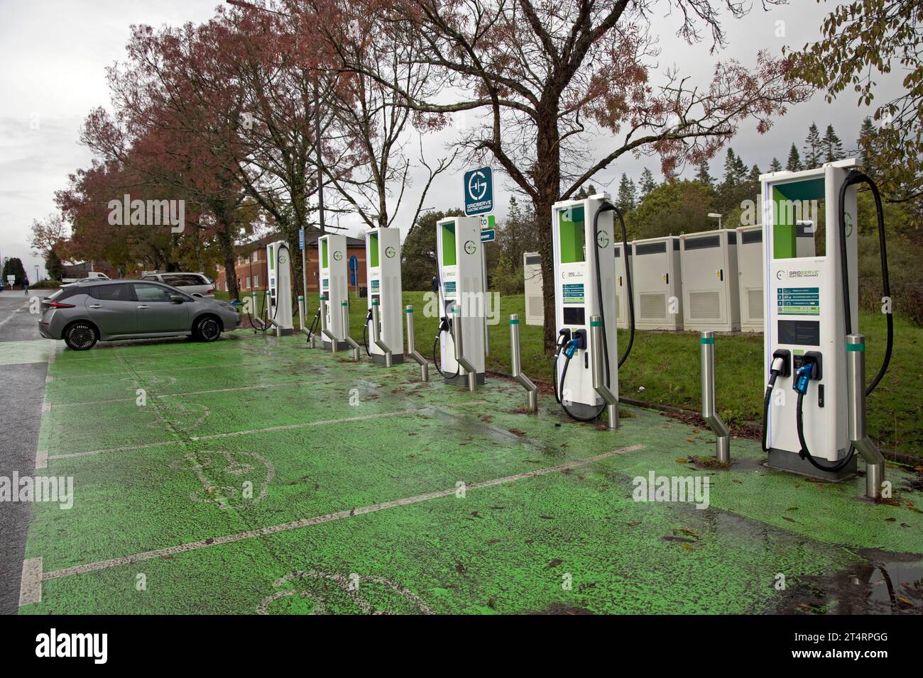 Nissan Lead electric car charging at banbk of chargers in rest area of