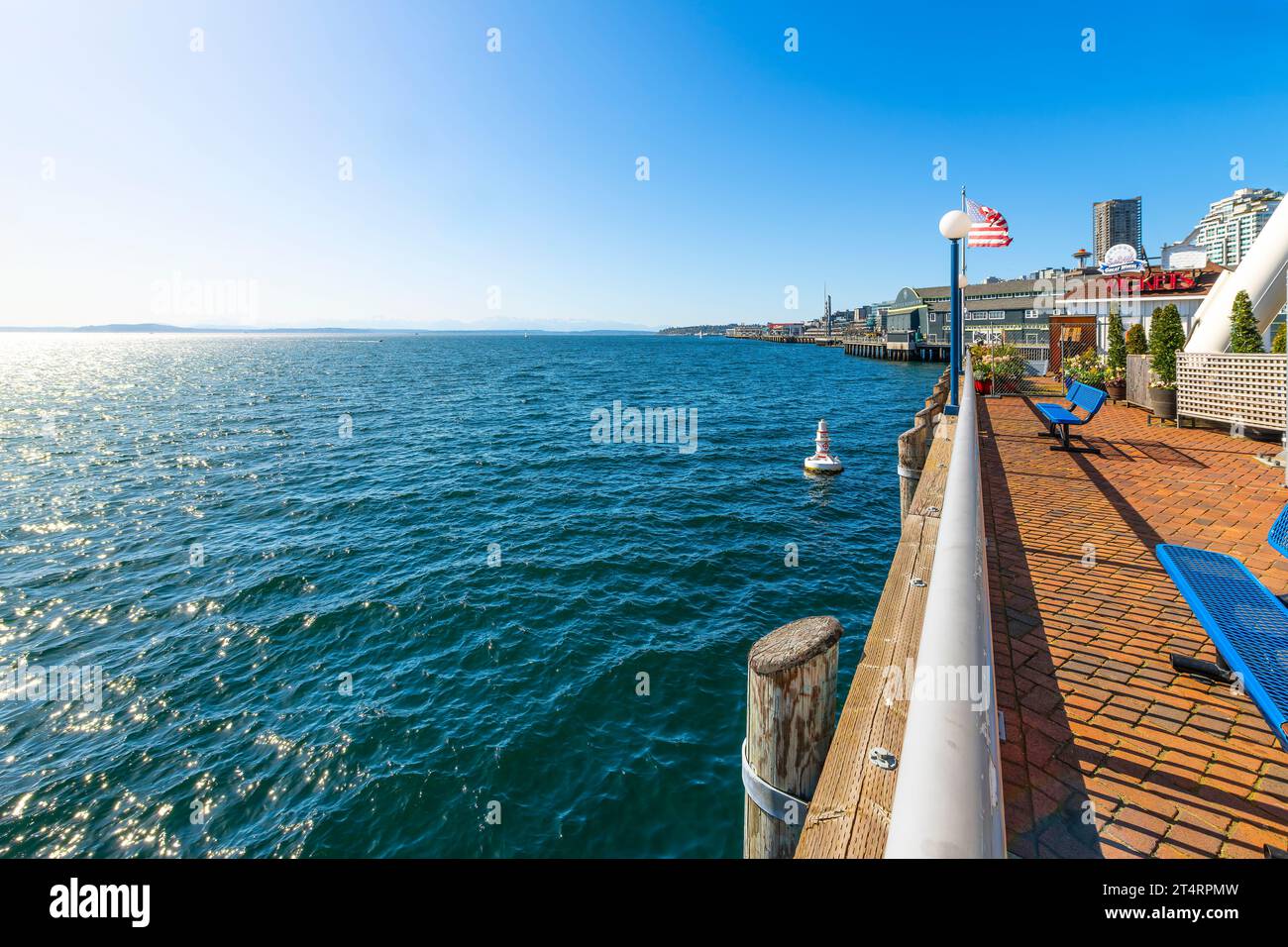 View from the Seattle waterfront promenade boardwalk and pier at the Great Wheel along Puget Sound overlooking Elliott Bay and the Pacific Ocean. Stock Photo