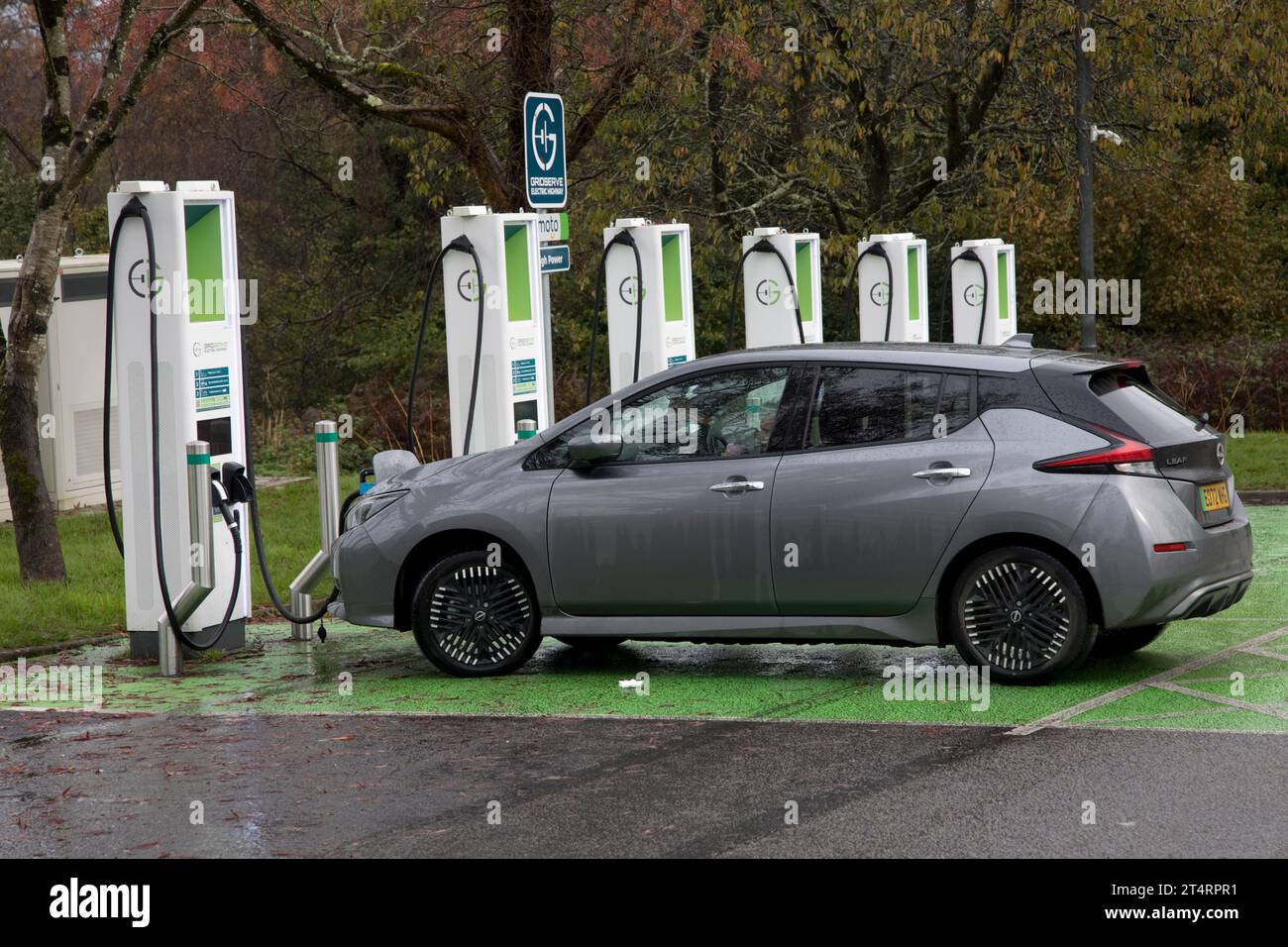 Nissan Lead electric car charging at banbk of chargers in rest area of