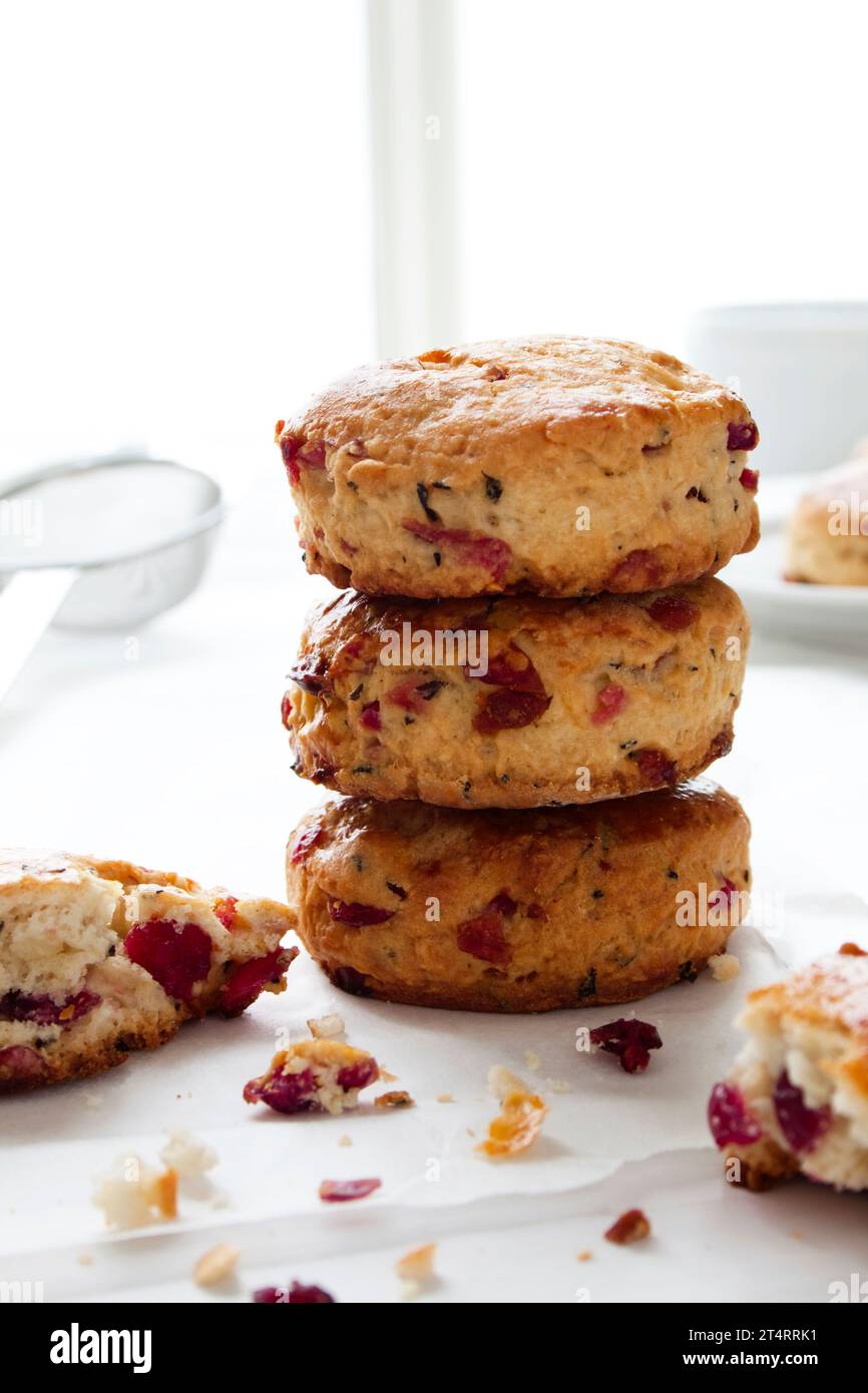 Homemade cranberry scones arranged in a stack, on baking parchment ...