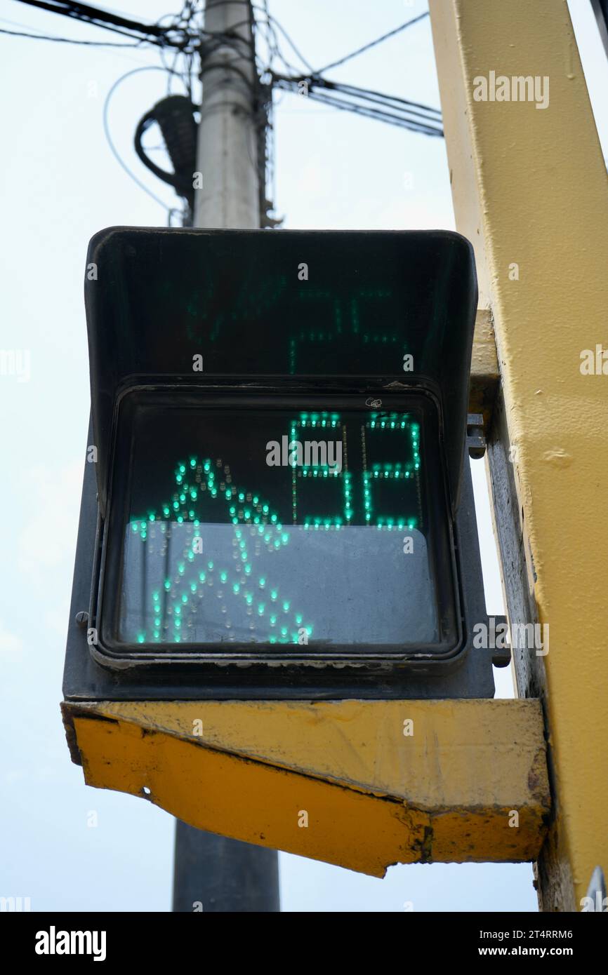 Green Walking Man road crossing sign. Miraflores, Peru. Stock Photo
