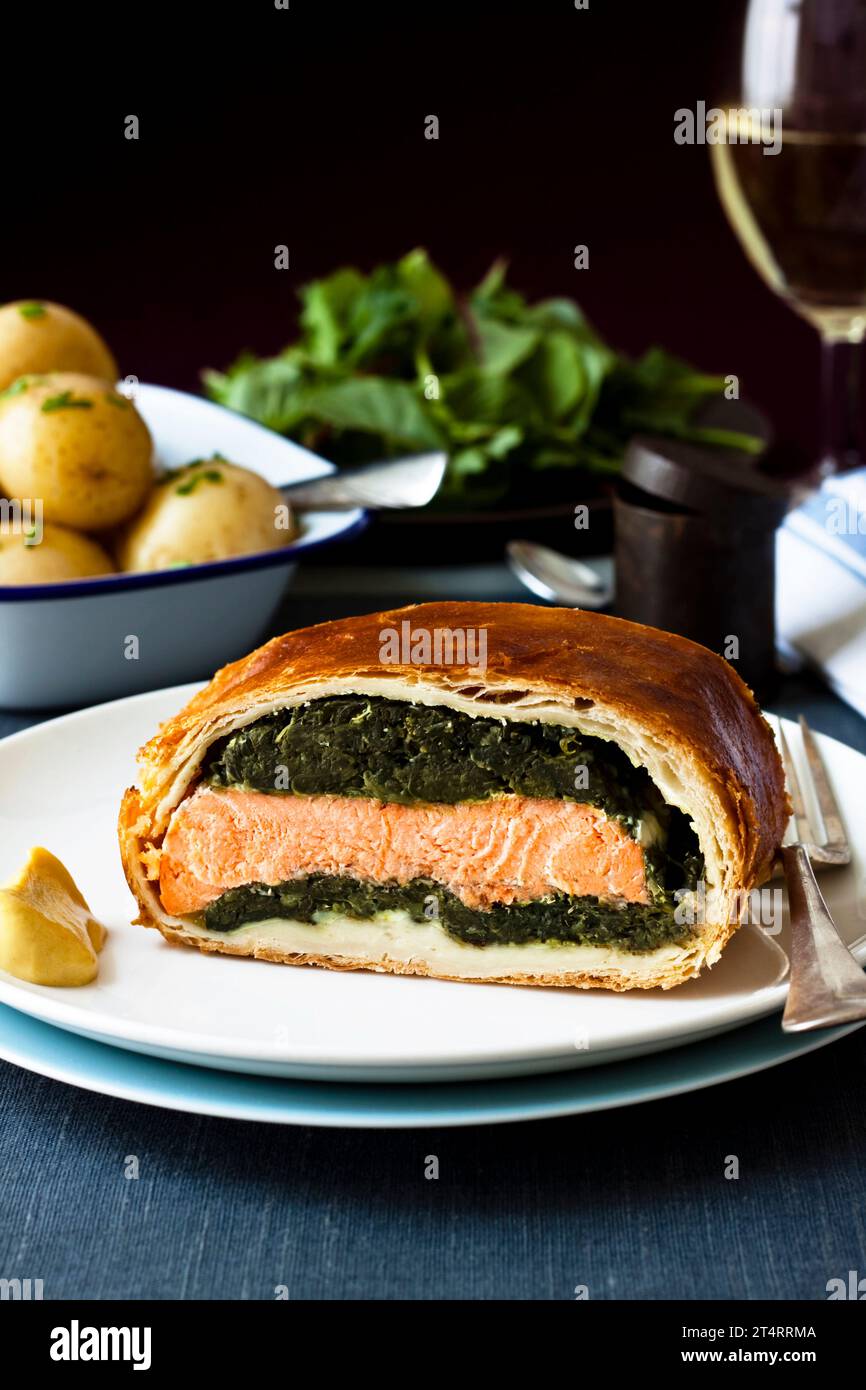 Salmon en croute with spinach and light puff pastry, served with new