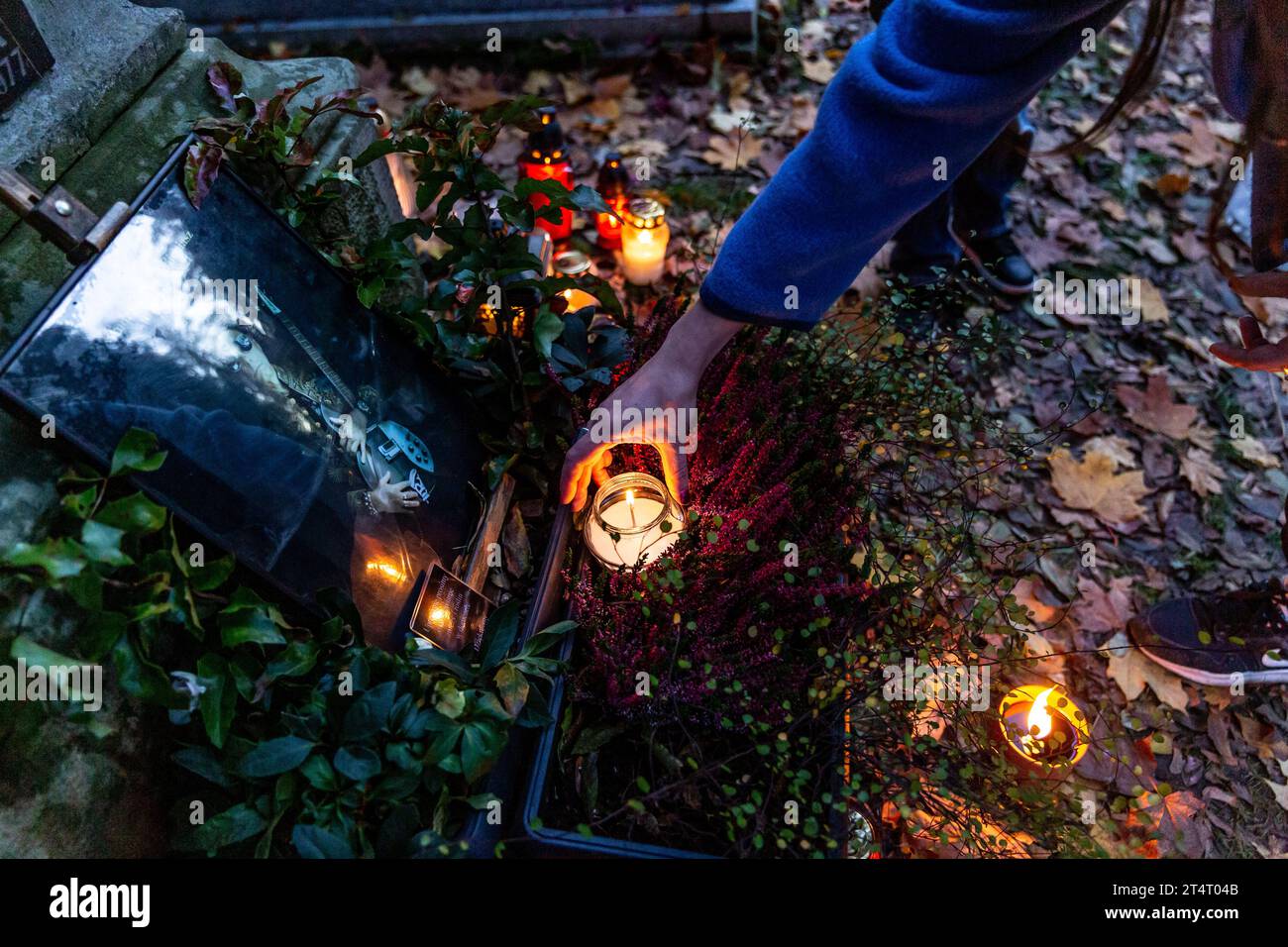 Krakow, Poland. 01st Nov, 2023. A woman lights a candle at the landmark